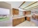 Kitchen features plenty of wooden cabinets and a view through the window at 9512 W Mcrae Way, Peoria, AZ 85382