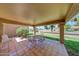 Charming covered patio features tiled flooring and room for seating, perfect for outdoor relaxation at 9512 W Mcrae Way, Peoria, AZ 85382