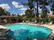 Relaxing community pool and lounge area perfect for sunny days, enhanced by lush landscaping at 9512 W Mcrae Way, Peoria, AZ 85382