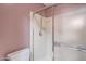 Shower with sliding glass doors and tile walls next to toilet in a bathroom at 9512 W Mcrae Way, Peoria, AZ 85382