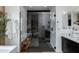 Contemporary bathroom with a glass-enclosed shower featuring dark herringbone tile and modern fixtures at 100 W Northern Ave # 8, Phoenix, AZ 85021
