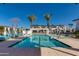 Sparkling community pool featuring cabanas, palm trees, and stylish lounge chairs offers a resort-like experience for residents at 100 W Northern Ave # 8, Phoenix, AZ 85021