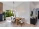 Bright dining room with wood floors, modern chandelier, and large windows overlooking greenery at 100 W Northern Ave # 8, Phoenix, AZ 85021