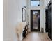 Bright entryway with hardwood floors, modern decor, and a black framed glass front door at 100 W Northern Ave # 8, Phoenix, AZ 85021