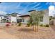 Landscaped modern home with a paver driveway and a black framed glass garage door at 100 W Northern Ave # 8, Phoenix, AZ 85021
