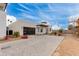 Modern home with a paver driveway, desert landscaping, and glass garage door at 100 W Northern Ave # 8, Phoenix, AZ 85021