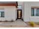 Contemporary home entrance featuring desert landscaping and a black front door at 100 W Northern Ave # 8, Phoenix, AZ 85021