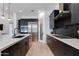 Open kitchen featuring a large island, stainless steel appliances, and black cabinetry at 100 W Northern Ave # 8, Phoenix, AZ 85021