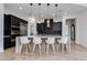 Modern kitchen with black cabinetry, stainless steel appliances, and a large center island at 100 W Northern Ave # 8, Phoenix, AZ 85021
