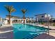 Inviting community pool with lounge chairs and swaying palms offers a refreshing oasis for residents under sunny skies at 100 W Northern Ave # 8, Phoenix, AZ 85021