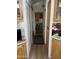 Hallway view showcases wood cabinets and a view into a carpeted bedroom at 1001 S Prospector Dr # 1001, Apache Junction, AZ 85119