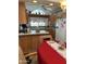 Cozy kitchen features wood cabinets and an island, accented by a red tablecloth at 1001 S Prospector Dr # 1001, Apache Junction, AZ 85119