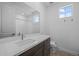 Contemporary bathroom with stylish vanity, white quartz countertop, modern fixtures, and a large mirror at 10224 E Utah Ave, Mesa, AZ 85212