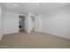 Empty bedroom with neutral carpet, white walls, and ample natural light from a doorway and windows at 10224 E Utah Ave, Mesa, AZ 85212
