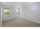 Spacious bedroom with three large windows offering plenty of natural light and neutral carpet flooring at 10224 E Utah Ave, Mesa, AZ 85212