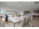 Elegant dining area with marble table, seating for six, and views to the living room and kitchen at 10224 E Utah Ave, Mesa, AZ 85212