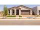 Charming single-story home with a stucco facade, a brick driveway, and manicured landscaping at 10224 E Utah Ave, Mesa, AZ 85212