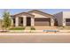 Charming home featuring a manicured front yard, a two-car garage, and inviting curb appeal in a friendly neighborhood at 10224 E Utah Ave, Mesa, AZ 85212
