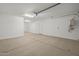 View of a two car garage with a water heater and epoxy floor at 10224 E Utah Ave, Mesa, AZ 85212