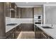 Modern kitchen featuring gray cabinets, stainless steel appliances, white subway tile backsplash, and quartz countertops at 10224 E Utah Ave, Mesa, AZ 85212