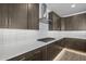 Stylish kitchen featuring dark cabinetry, white subway tile backsplash, and gas cooktop at 10224 E Utah Ave, Mesa, AZ 85212