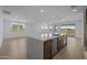 Large kitchen island with stainless steel appliances, wood floors, and natural light at 10224 E Utah Ave, Mesa, AZ 85212