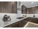 Countertop with stainless appliances, cooktop, and dark cabinets at 10224 E Utah Ave, Mesa, AZ 85212