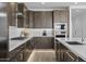 Modern kitchen featuring gray cabinets, stainless steel appliances, white subway tile backsplash, and quartz countertops at 10224 E Utah Ave, Mesa, AZ 85212