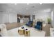 Open living and dining area with a modern kitchen, stylish furniture, and natural light at 10224 E Utah Ave, Mesa, AZ 85212