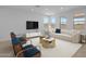 Comfortable living room featuring a modern sofa, stylish chairs, and ample natural light at 10224 E Utah Ave, Mesa, AZ 85212