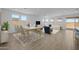 Bright, open-concept living room with a dining area and large windows at 10224 E Utah Ave, Mesa, AZ 85212