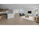 Open-concept living space featuring a seating area, kitchen and dining space with light wood flooring at 10224 E Utah Ave, Mesa, AZ 85212