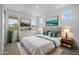 Beautifully staged bedroom with calm decorations, three windows, and an inviting white plush rug at 10224 E Utah Ave, Mesa, AZ 85212