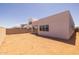 Spacious backyard, perfect for customization and outdoor activities, complemented by modern home architecture and neighborhood views at 10230 E Utah Ave, Mesa, AZ 85212