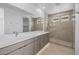 Modern bathroom with double vanity, frameless glass shower, and tile surround at 10230 E Utah Ave, Mesa, AZ 85212