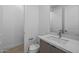 Modern bathroom featuring white marble counters, a large mirror, and a toilet at 10230 E Utah Ave, Mesa, AZ 85212
