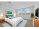 Beautifully staged bedroom with three bright windows, neutral carpet, and stylish decor at 10230 E Utah Ave, Mesa, AZ 85212