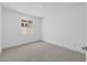 Empty bedroom with neutral carpeting, baseboards, single window and white walls at 10230 E Utah Ave, Mesa, AZ 85212
