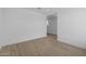 Bright, unfurnished bedroom with wood-look flooring. Doorway leads to other rooms at 10230 E Utah Ave, Mesa, AZ 85212