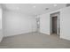 Spacious room with neutral carpet, white walls and ceiling, and an adjacent bathroom at 10230 E Utah Ave, Mesa, AZ 85212