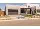 Modern home with clean lines, a dark brown garage door, and low maintenance desert landscaping at 10230 E Utah Ave, Mesa, AZ 85212