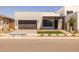 Modern home featuring a minimalist design, a dark brown garage door, and low maintenance landscaping at 10230 E Utah Ave, Mesa, AZ 85212
