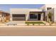 Contemporary home featuring a two-car garage, modern landscaping, and inviting entryway, enhancing curb appeal and neighborhood charm at 10230 E Utah Ave, Mesa, AZ 85212