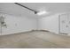 Spacious garage with concrete floors, white walls, and multiple doors at 10230 E Utah Ave, Mesa, AZ 85212