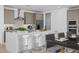 Modern kitchen features stainless steel appliances, a center island with quartz countertops, and stylish gray cabinetry at 10230 E Utah Ave, Mesa, AZ 85212