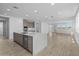 Bright, open-concept kitchen features a large island with quartz countertops, stainless steel appliances, and light wood flooring at 10230 E Utah Ave, Mesa, AZ 85212