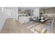 Modern eat-in kitchen featuring stainless steel appliances, white quartz counters, and an island with seating at 10230 E Utah Ave, Mesa, AZ 85212