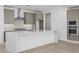 Modern kitchen features stainless steel appliances, a center island with quartz countertops, and stylish gray cabinetry at 10230 E Utah Ave, Mesa, AZ 85212