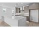 Bright kitchen features a large center island with quartz countertops and stainless steel appliances at 10230 E Utah Ave, Mesa, AZ 85212