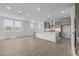 Bright, open-concept kitchen with a large island, modern cabinets, and sleek stainless steel appliances at 10230 E Utah Ave, Mesa, AZ 85212